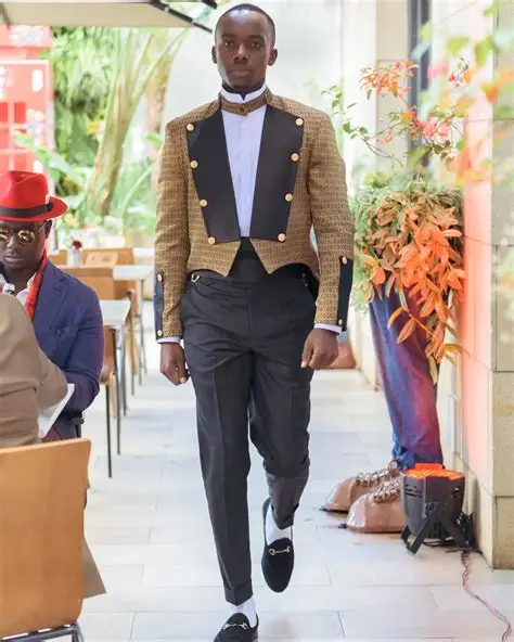 Client in a gold brocade Ashok tuxedo on a runway